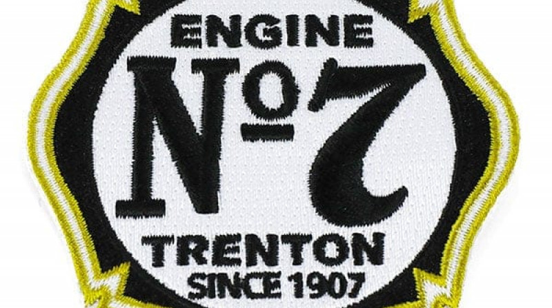 Gold, black, and white embroidered patch in the shape of a Maltese cross with the text: Engine No. 7, Trenton, Since 1907